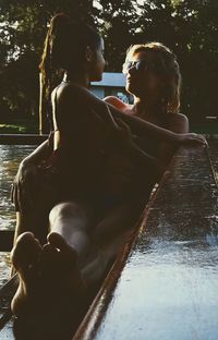 Rear view of young woman in water