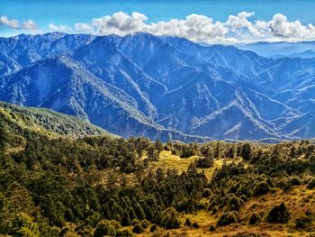 Scenic view of mountains against blue sky