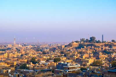 High angle view of buildings in city against clear sky