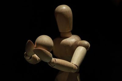 Close-up of figurine against black background