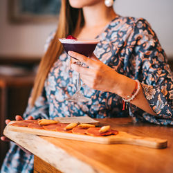 Midsection of woman preparing food on table at home