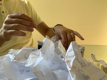 Midsection of man holding crumpled paper