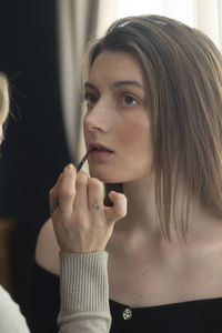 Portrait of young woman holding cigarette