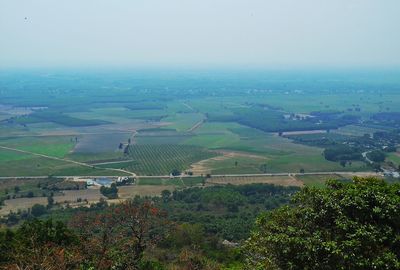 Scenic view of grassy field against sky