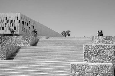 Low angle view of staircase against building against clear sky