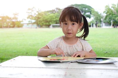 Portrait of cute girl on table