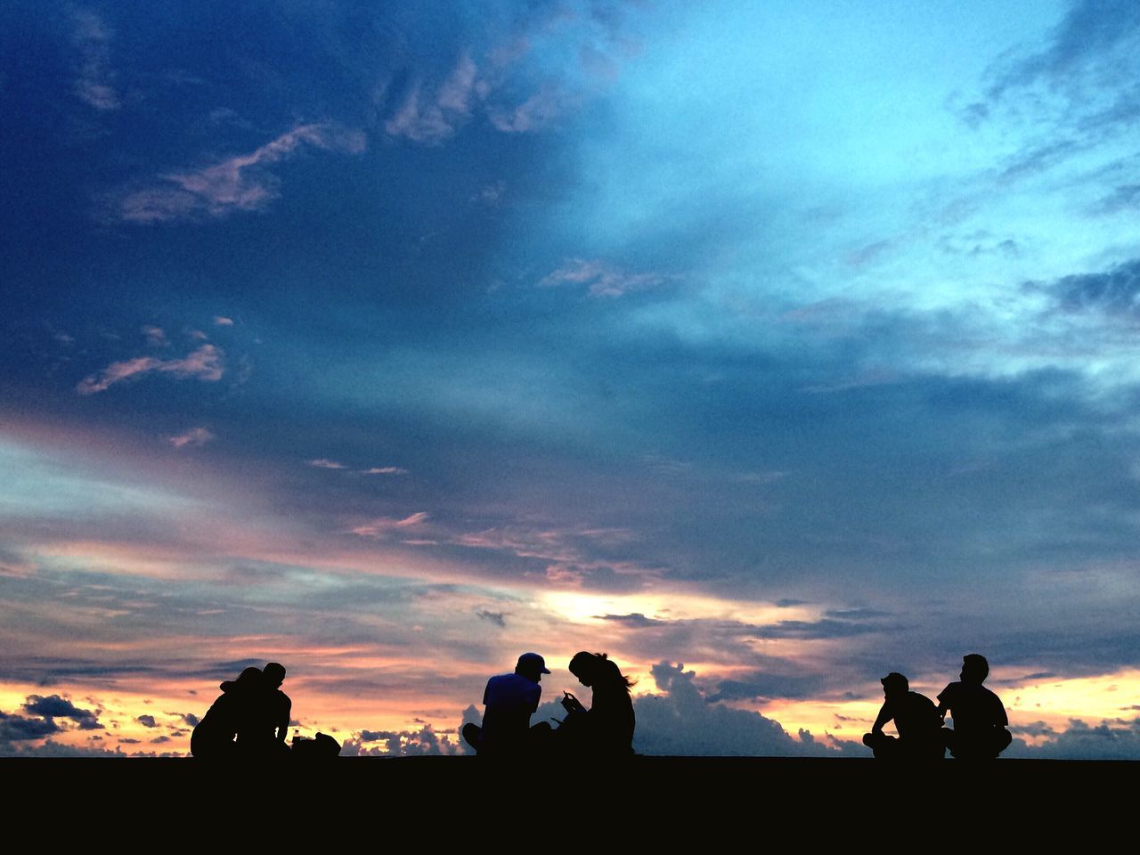 SILHOUETTE PEOPLE AGAINST DRAMATIC SKY