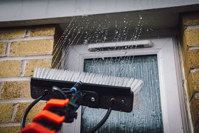 Close-up of wet window of building