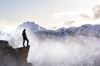 Man standing on mountain against sky