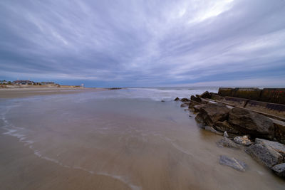 View of beach against cloudy sky