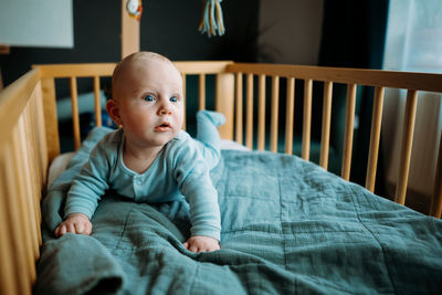 Cute baby looking away in crib