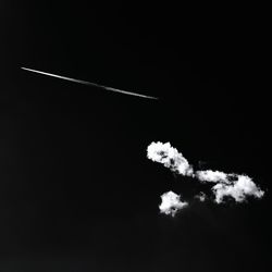 Low angle view of vapor trail against sky at night