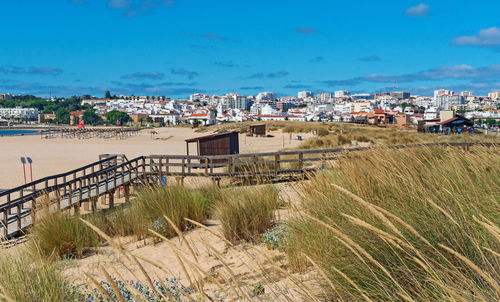 Scenic view of beach against buildings in city