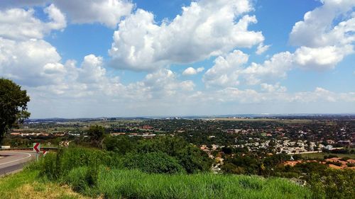 View of cityscape against cloudy sky