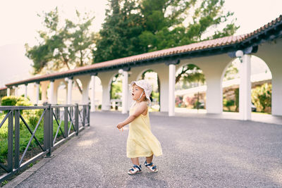 Full length of woman on bridge against plants