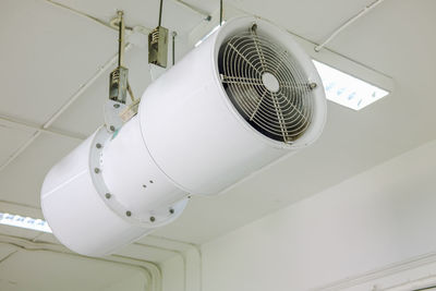 Low angle view of electric fan hanging from ceiling