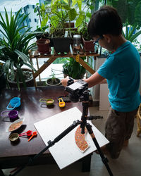 Side view of boy holding table