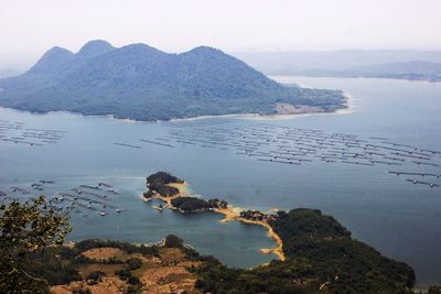 Scenic view of sea and mountains against sky