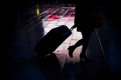 Low section of people walking on wet street