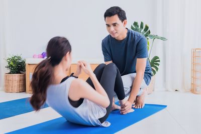 Young couple sitting on wall