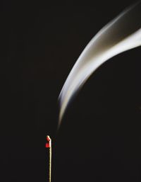 Close-up of illuminated lighting equipment against black background