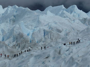 Group of people on snowcapped mountain