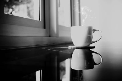 Close-up of coffee cup on table at home