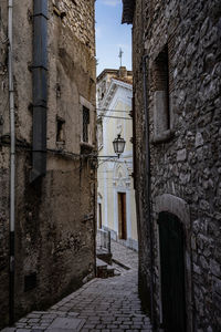 Alley amidst old buildings in city