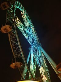 Low angle view of illuminated ferris wheel at night