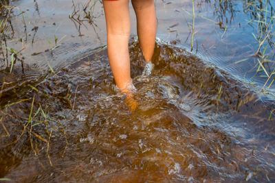 Low section of woman standing on beach