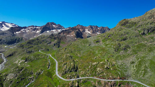 Scenic view of mountains against clear blue sky