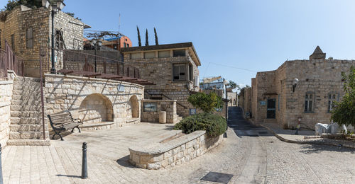 Old buildings in city against clear sky