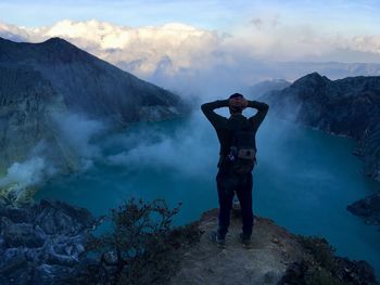 Full length of man standing on mountain against sky