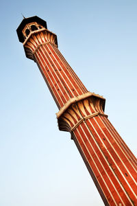 Low angle view of historic column against clear blue sky