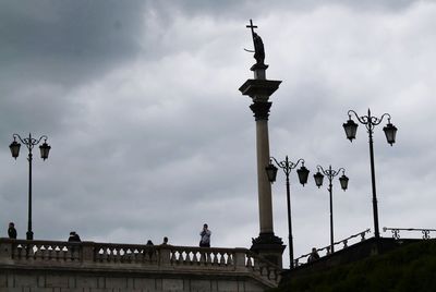 Low angle view of street light against cloudy sky