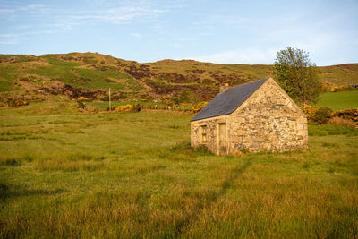 House on field against sky