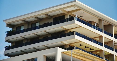 Low angle view of office building against clear sky