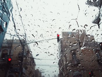 Road seen through wet window during rainy season