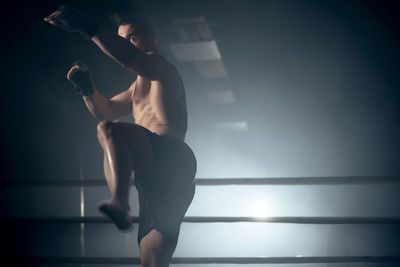 Side view of woman exercising at gym