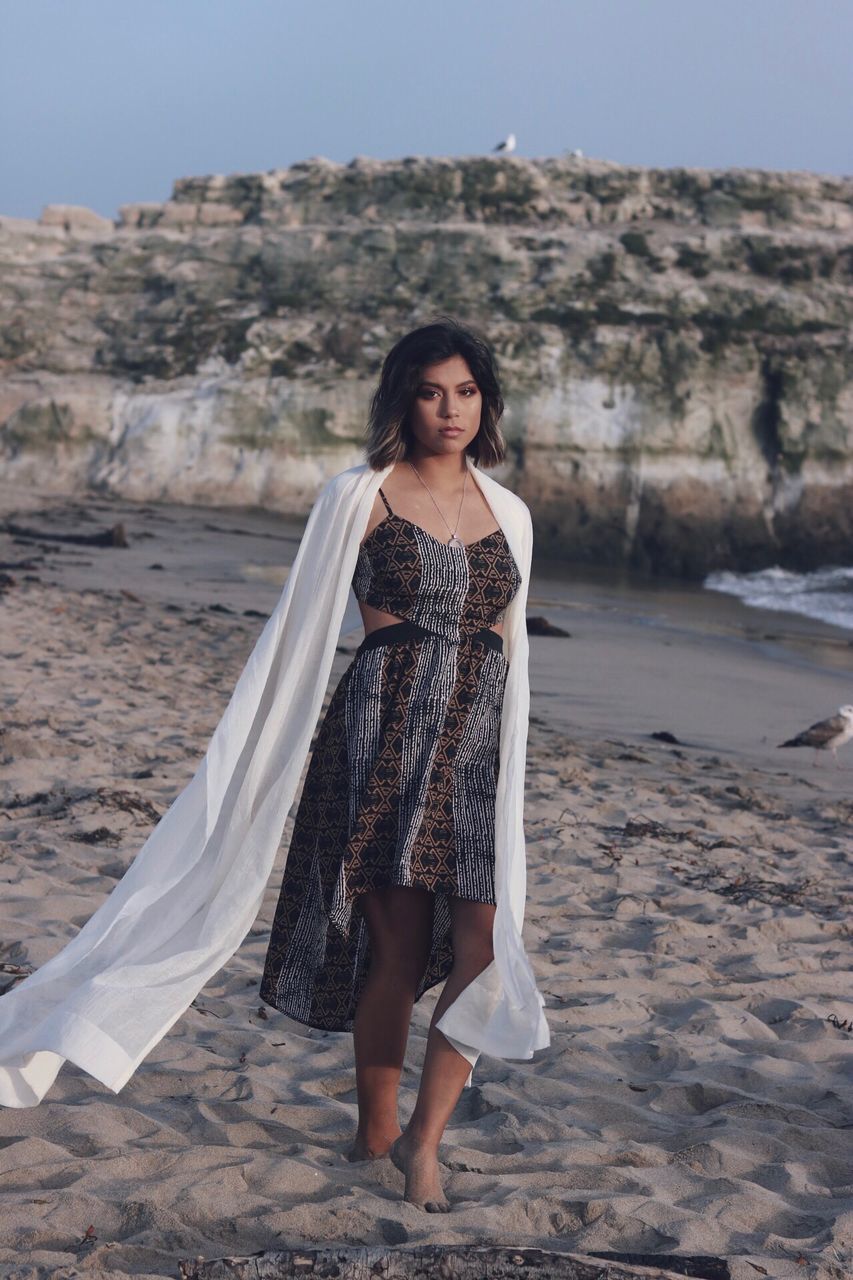 real people, young adult, one person, full length, young women, front view, beautiful woman, standing, looking at camera, lifestyles, casual clothing, leisure activity, portrait, focus on foreground, nature, sand, outdoors, beach, day, sky