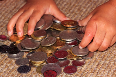 Cropped hand of person holding coins