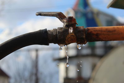Close-up of water drops on rusty pipe