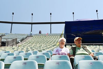 Couple sitting on chairs at auditorium