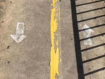 High angle view of markings and shadow on road