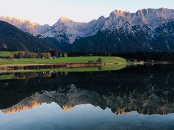 Scenic view of lake and mountains against sky