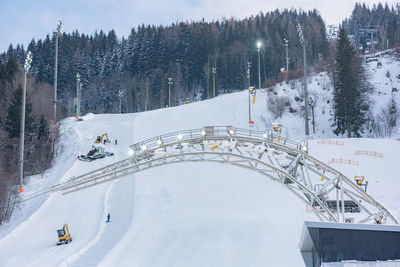 View of people skiing on snow covered mountain