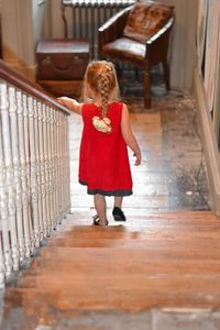 Rear view of girl moving down on staircase