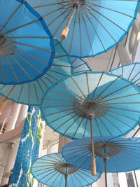 Low angle view of multi colored umbrellas hanging