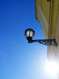 Low angle view of lamp against clear blue sky