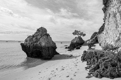 Rocks on beach against sky